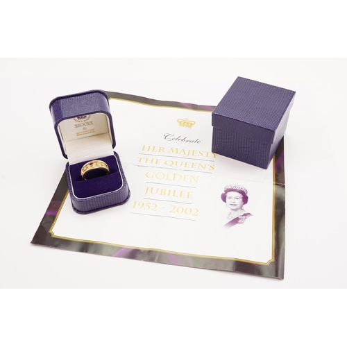 191 - A Brooks & Bentley Golden Jubilee 9ct gold ring in presentation box. Set with Garnets, Sapphires and... 