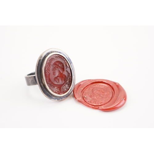 230 - A intaglio set ring, set with a carved carnelian.