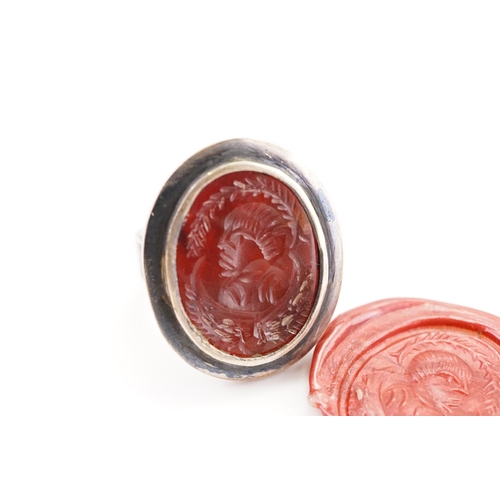 230 - A intaglio set ring, set with a carved carnelian.