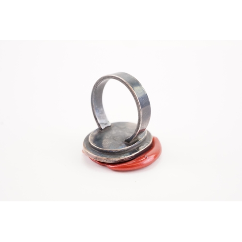 230 - A intaglio set ring, set with a carved carnelian.