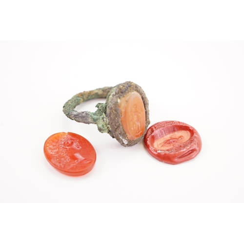 231 - A interesting period intaglio set ring, set with a carved carnelian depicting a women, along with a ... 