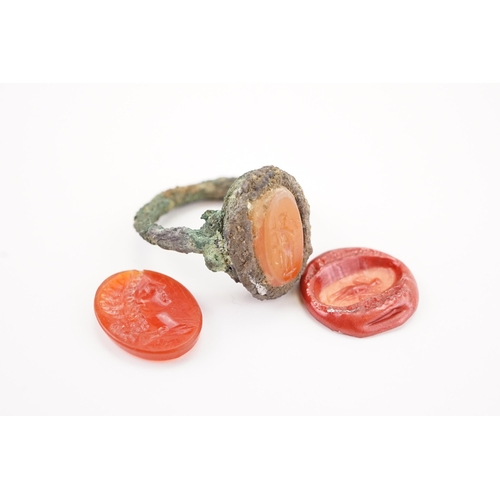 231 - A interesting period intaglio set ring, set with a carved carnelian depicting a women, along with a ... 