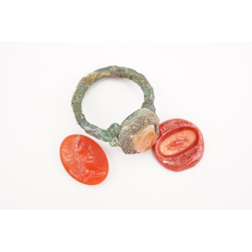 231 - A interesting period intaglio set ring, set with a carved carnelian depicting a women, along with a ... 