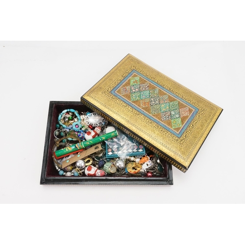 238 - A wooden lacquered box containing costume jewellery, including beads, earrings etc.