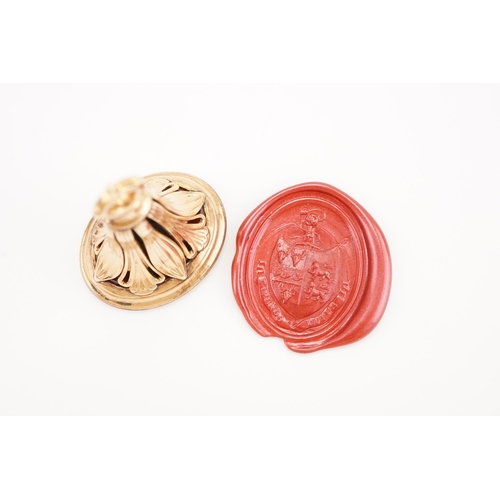 229 - A 14ct gold Georgian intaglio seal, set with a carnelian carved with a coat of arms, depicting a fis... 