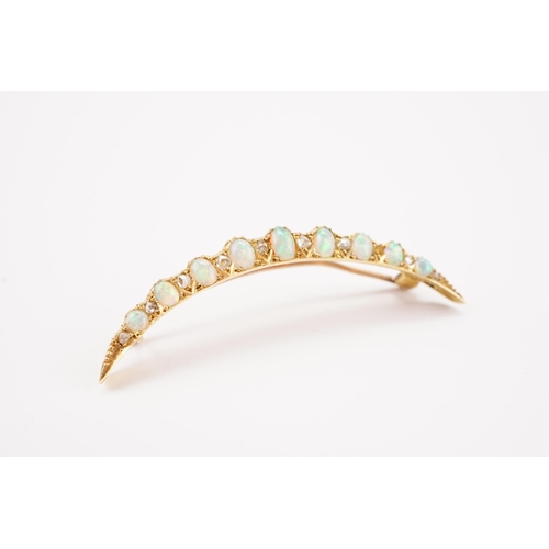 196 - A 9ct gold Victorian opal and paste set moon brooch, set with 9 opals.