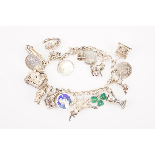 199 - A silver charm bracelet, hung with various charms, swan, enamelled etc. Weight 46.4g.