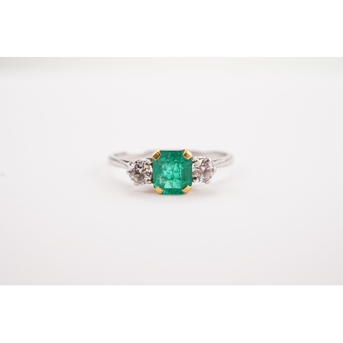 207 - A platinum mounted emerald and diamond set ring, set with a cushion cut emerald 5.4 x 6. Two diamond... 