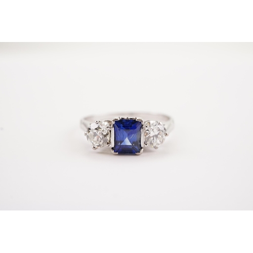 208 - A platinum synthetic sapphire and paste set ring. Sapphire size 6.2 x 4.3. Size S.