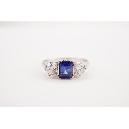 208 - A platinum synthetic sapphire and paste set ring. Sapphire size 6.2 x 4.3. Size S.