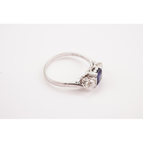 208 - A platinum synthetic sapphire and paste set ring. Sapphire size 6.2 x 4.3. Size S.