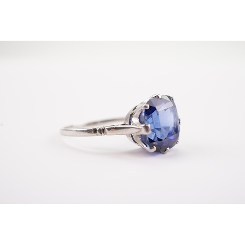 209 - A large synthetic sapphire set ring, in a platinum mount. Sapphire size approx 3ct. 9.3 x 10.2 x 7.5... 