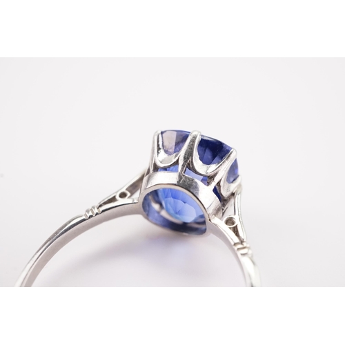 209 - A large synthetic sapphire set ring, in a platinum mount. Sapphire size approx 3ct. 9.3 x 10.2 x 7.5... 