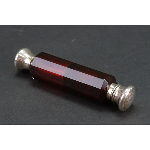 52 - A ruby glass and silver (unmarked) topped double ended scent bottle.