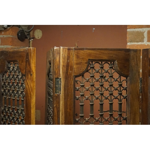 518 - A Pair of Moroccan Three Folding Hardwood & Wrought Iron Screens with panelled bases. Measuring: 185... 