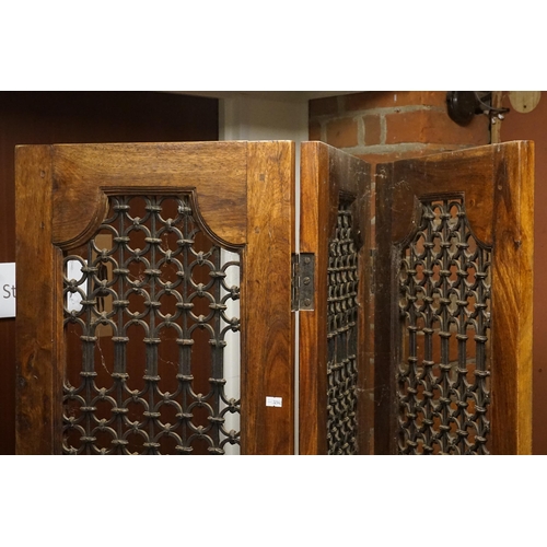 518 - A Pair of Moroccan Three Folding Hardwood & Wrought Iron Screens with panelled bases. Measuring: 185... 