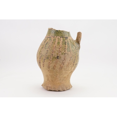 780 - A Late Hellenistic Hand Made Pottery Wine Jug with a Green Glaze. Measuring: 23cms High. (AF).