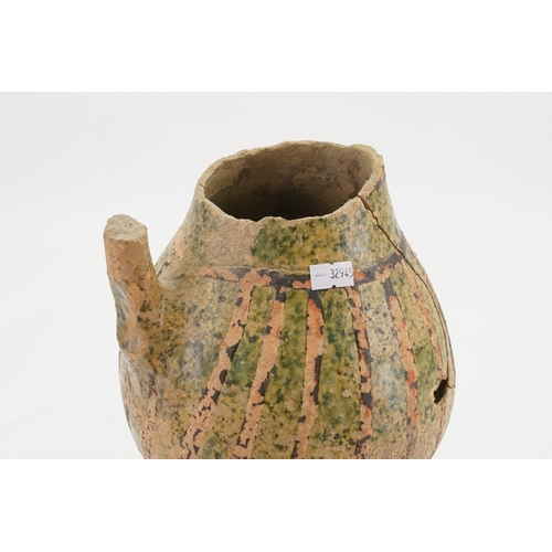 780 - A Late Hellenistic Hand Made Pottery Wine Jug with a Green Glaze. Measuring: 23cms High. (AF).