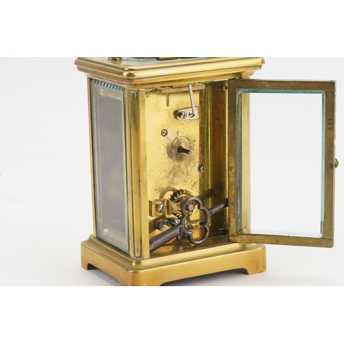 274 - A French Brass Cased Carriage Clock with visible escapement, Enamel Dial & Key.