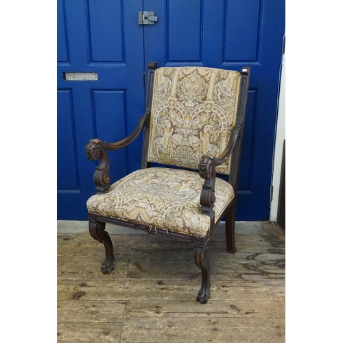 527 - An Irish designed Carved Mahogany Throne Chair decorated with Stylised Faces with Moustaches resting... 