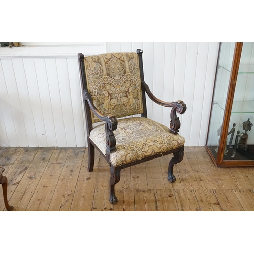 527 - An Irish designed Carved Mahogany Throne Chair decorated with Stylised Faces with Moustaches resting... 