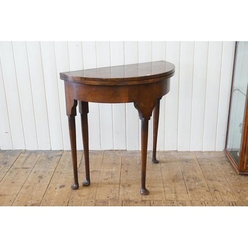 524 - A Queen Anne design Walnut Fold-Over Top Table resting on elongated Pad Feet. Measuring: 76cms acros... 