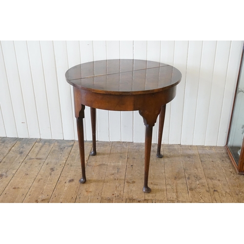 524 - A Queen Anne design Walnut Fold-Over Top Table resting on elongated Pad Feet. Measuring: 76cms acros... 