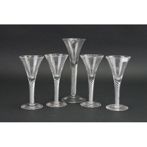 724 - An Antique Air Twist Trumpet Shaped Wine Glass on a raised base & Four modern Wine Glasses.