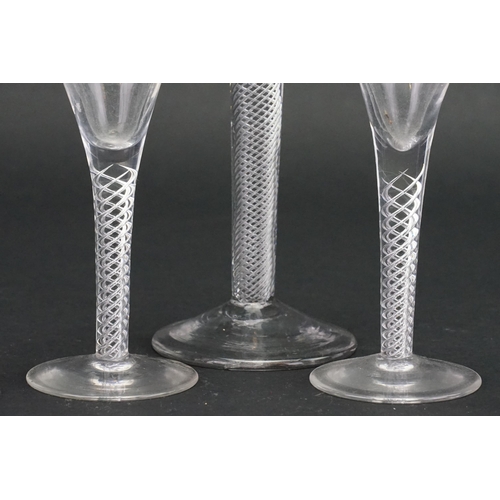 724 - An Antique Air Twist Trumpet Shaped Wine Glass on a raised base & Four modern Wine Glasses.