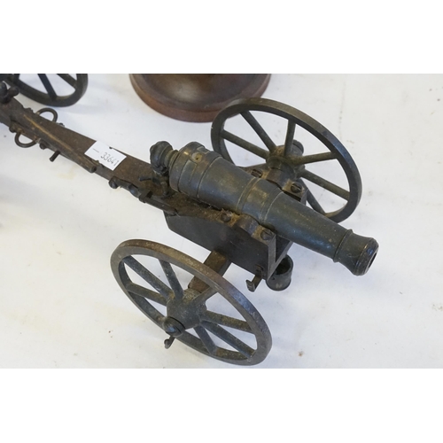 437 - A Cast model of a Field Gun on Carriage with a Fire Bucket & Twist Mechanism & Two Treen Circular Dr... 