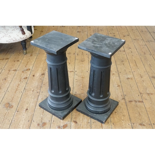 486 - A Pair of Ebonised Fluted Columns of turned & square proportioned Pillars. Measuring: 65cms high.