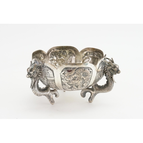 14 - A Chinese Export Silver Dragon bowl, circa 1900s, decorated with dragons and scenes. Seal mark to ba... 