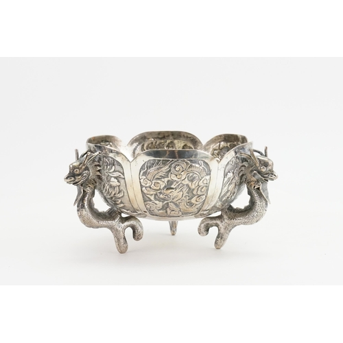 14 - A Chinese Export Silver Dragon bowl, circa 1900s, decorated with dragons and scenes. Seal mark to ba... 