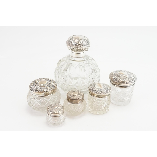 15 - A Collection of various Silver topped cut glass dressing table bottles.