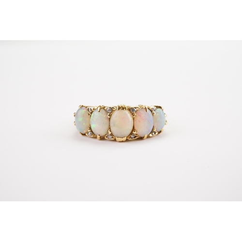 134 - An Opal and Diamond set Ring, set with five fiery white Opals and eight Diamonds, mounted in a 18ct ... 