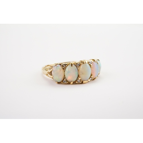 134 - An Opal and Diamond set Ring, set with five fiery white Opals and eight Diamonds, mounted in a 18ct ... 