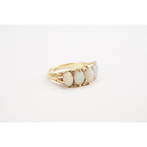 134 - An Opal and Diamond set Ring, set with five fiery white Opals and eight Diamonds, mounted in a 18ct ... 