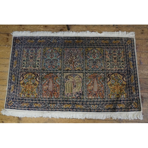 570 - A Cashmere Silk Rug designed with Ten Floral decorated Cartouches & a Tiger Quadruple Border. Measur... 