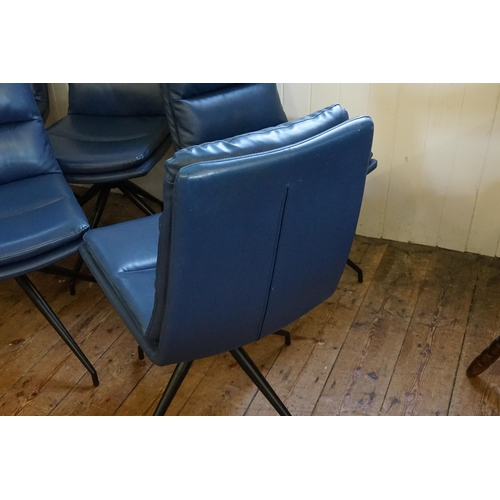 500 - A Set of Six Modern Over Stuffed Swivel Dark Blue Dining Chairs resting on a 1950s design Legs.