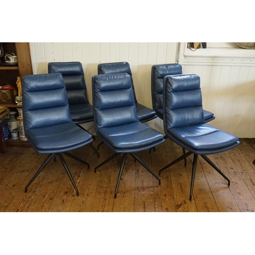 500 - A Set of Six Modern Over Stuffed Swivel Dark Blue Dining Chairs resting on a 1950s design Legs.