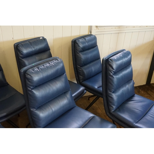 500 - A Set of Six Modern Over Stuffed Swivel Dark Blue Dining Chairs resting on a 1950s design Legs.