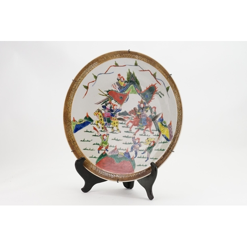 295 - A Chinese Large Saucer Dish decorated with marauding Warriors. Measuring: 38cms.