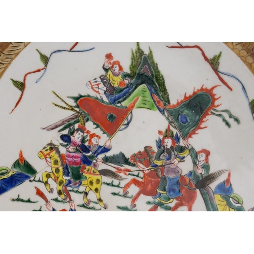 295 - A Chinese Large Saucer Dish decorated with marauding Warriors. Measuring: 38cms.