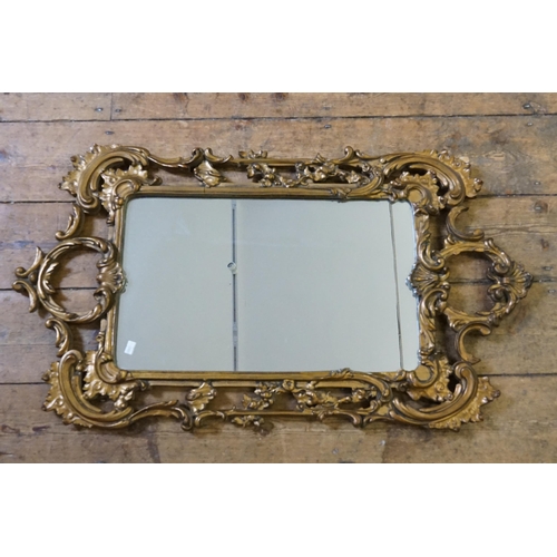 562 - An Oval Gilt Framed Wall Mirror in Gesso. Measuring 55cms x 48cms. Along with one other.