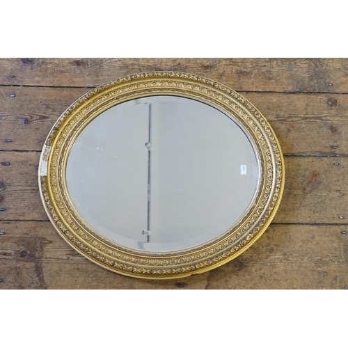 562 - An Oval Gilt Framed Wall Mirror in Gesso. Measuring 55cms x 48cms. Along with one other.