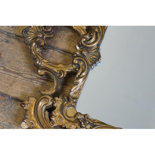 562 - An Oval Gilt Framed Wall Mirror in Gesso. Measuring 55cms x 48cms. Along with one other.