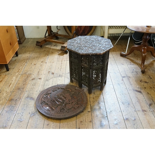 475 - An Indian Cashmere Carved Folding Tea Table & a Circular Chinese Plaque.