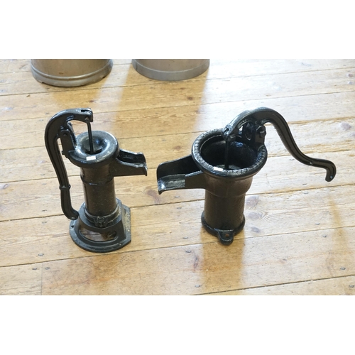 585 - A Cast Iron Water Pump & one other in Black.