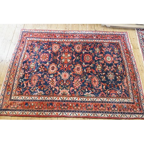 569 - A Red Ground All Over Floral Pattern & Twin Beige bordered Maltese Cross Rug. Measuring: 227cms x 16... 