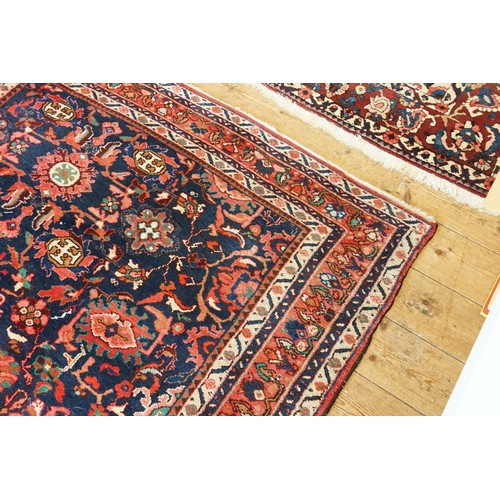 569 - A Red Ground All Over Floral Pattern & Twin Beige bordered Maltese Cross Rug. Measuring: 227cms x 16... 